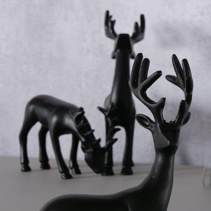 Three Seran matte black deer figurines arranged in assorted poses