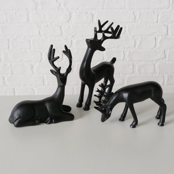 Three assorted handcrafted black aluminium Seran deer figurines