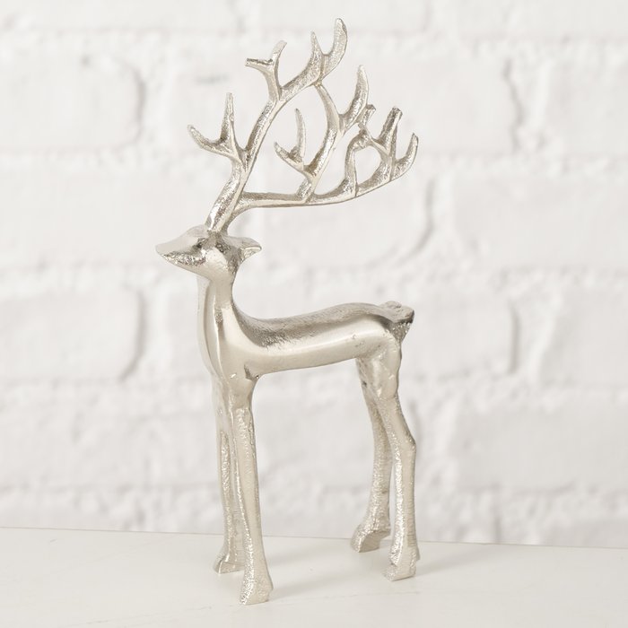 Silver nickel-plated aluminium standing stag figurine with dramatic branching antlers against white brick wall background