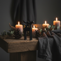 Rustic black moose ornament styled in a cosy Nordic home setting