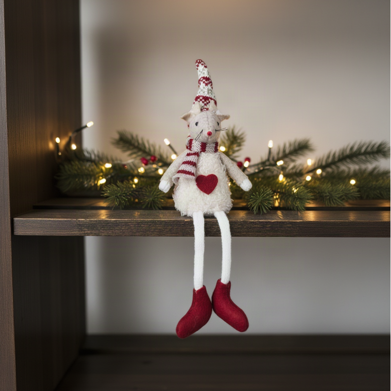 Fabric sitting mouse with Nordic hat displayed on a dark wooden shelf with fairy lights and pine sprigs