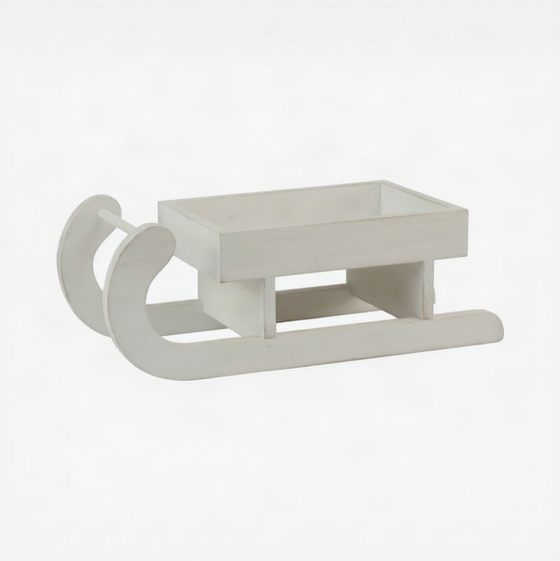 Small wooden whitewash decorative sleigh with curved runners on a white background